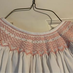 White dress with pink smocking